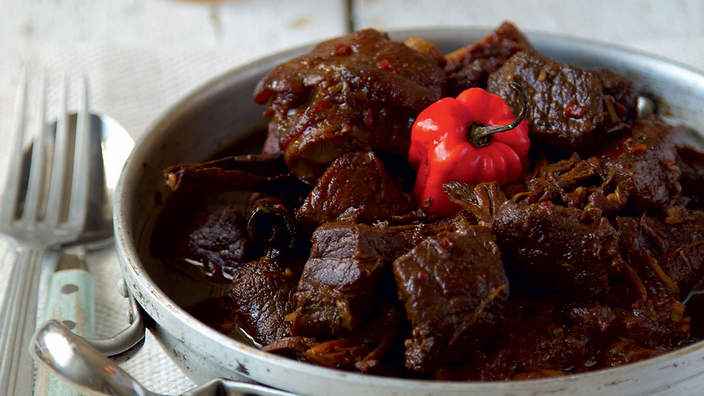 Dark pepperpot stew served in a bowl