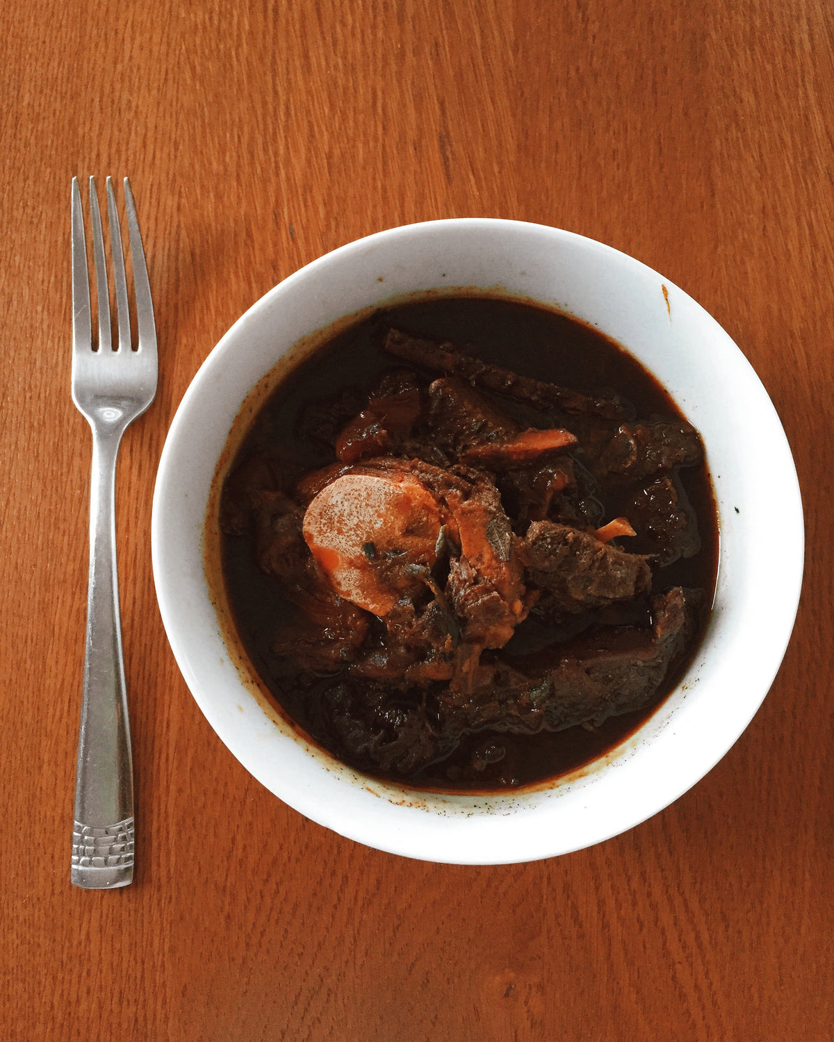 Bowl of Guyanese pepperpot traditionally served during the Christmas season